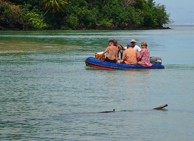 Claude brings more picnickers to the beach in the dinghy